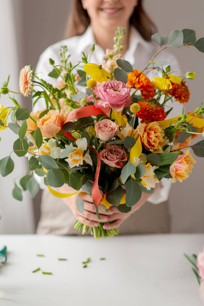 happy woman with bunch of flowers at studio - Zdjęcie, obraz