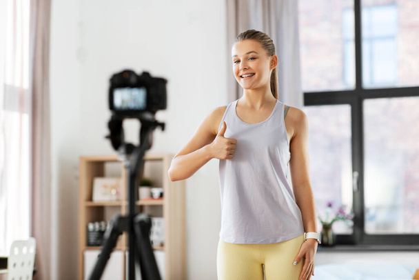 teenage girl or blogger recording gym class video - Foto, imagen