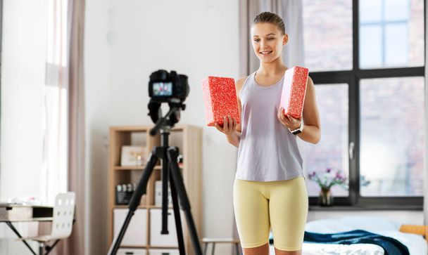 teenage girl or blogger recording gym class video - Fotó, kép