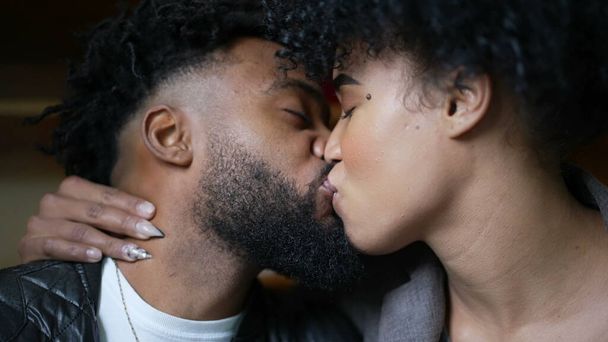 Passionate kiss a black couple kissing an African man and woman love - 写真・画像
