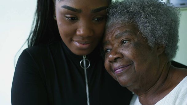 Generational women portrait faces a grandmother and granddaughter posing for camera together - Photo, Image