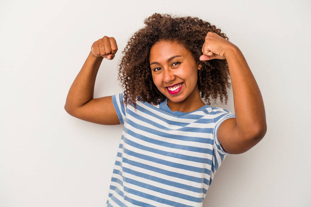Young african american woman with curly hair isolated on white background cheering carefree and excited. Victory concept. - Foto, Imagem