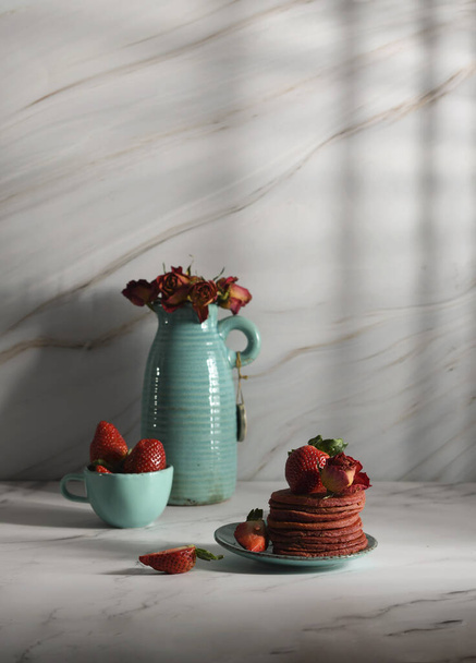 still life with Pink strawberry pancakes on a turquoise plate with sour cream - Fotografie, Obrázek