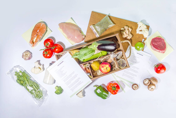 Maaltijden Kit levering Concept. Stel verschillende gezonde gerechten voedselingrediënten vlees, groenten, fruit, specerijen met recepten voor het koken. Online bestellen chef-kok voedsel ingrediënten, boodschappenbezorging - Foto, afbeelding