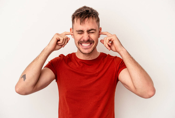 Young caucasian man isolated on white background celebrating a victory or success, he is surprised and shocked. - Foto, afbeelding
