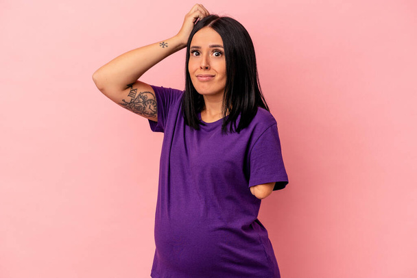 Young pregnant woman with one arm isolated on pink background being shocked, she has remembered important meeting. - Photo, Image