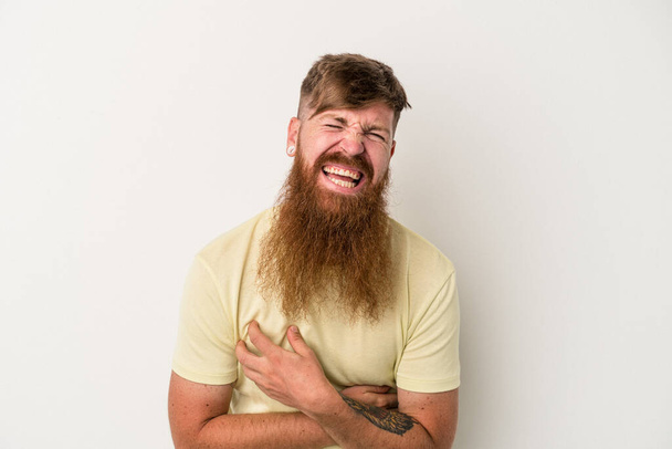 Young caucasian ginger man with long beard isolated on white background laughing and having fun. - Foto, Imagen