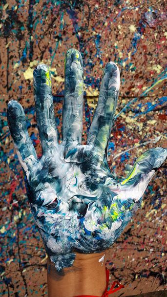hand with a painted palms in the hands of a woman - 写真・画像