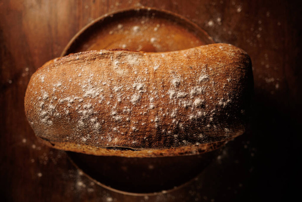 fresh baked bread on a wooden background - Фото, зображення