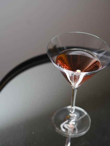 glass of cognac with red wine on a black background - Fotó, kép
