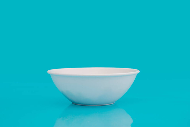 white bowl on blue background - Foto, Imagem
