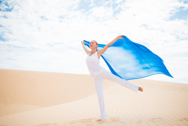 Young woman with flying blue scarf - Foto, imagen