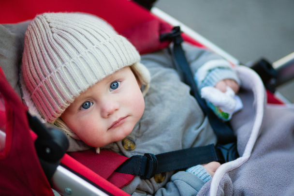 Little boy with blue eyes in a stroller - Photo, image