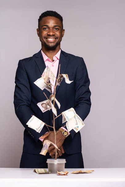 young african american man with money in studio - Fotó, kép