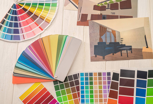 sala foto con catalogo colorato sdraiato sul tavolo, pianta di ristrutturazione casa  - Foto, immagini