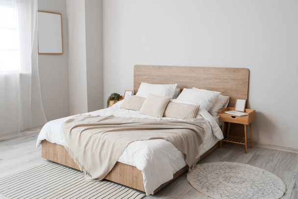 Comfortable bed and nightstands in room - Foto, Imagem