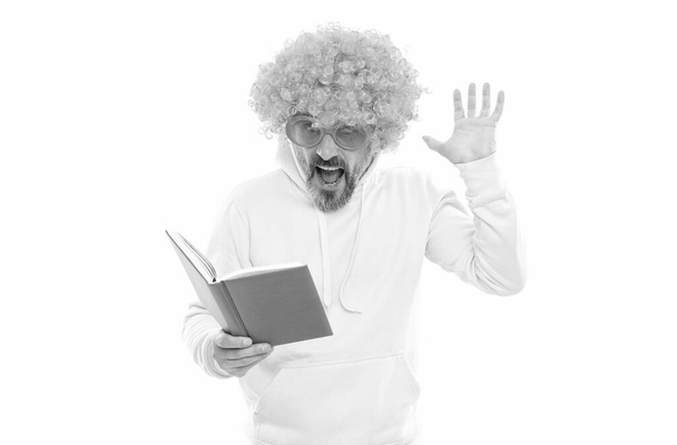 Literary fan. Surprised nerd in wig read book. Examination in literary English - Photo, Image