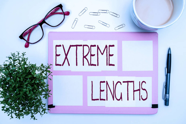 Text caption presenting Extreme Lengths. Word for Make a great or extreme effort to do something better Office Supplies Over Desk With Keyboard And Glasses And Coffee Cup For Working - Photo, Image