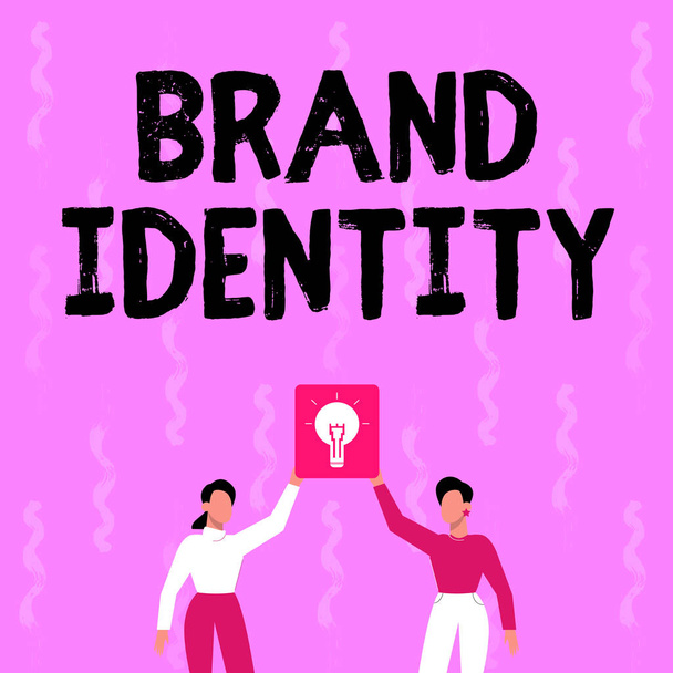 Conceptual caption Brand Identity. Business overview visible elements of a brand that identify and distinguish Two Colleagues Holding Lamp Presenting New Achievement Reached. - Photo, Image