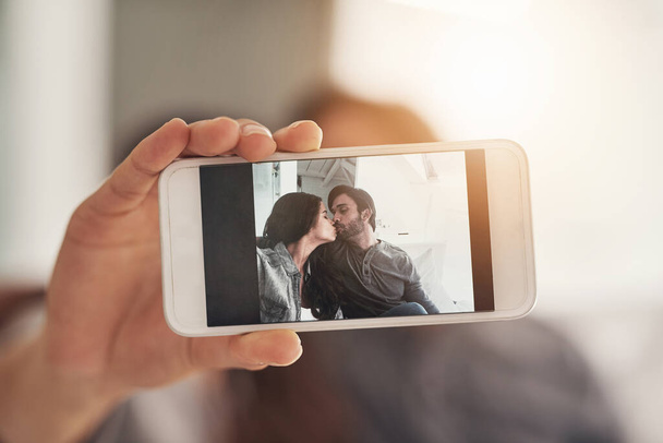 Sweet selfies with the sweetheart. Shot of an attractive young couple spending quality time at home. - Foto, Bild