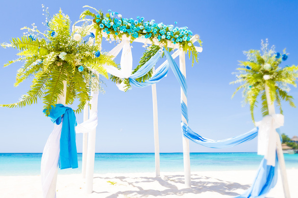 wedding arch decorated with flowers on tropical sand beach, outd - Photo, Image