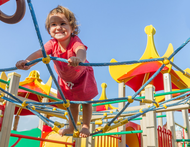 cute happy child girl on playground - Фото, изображение