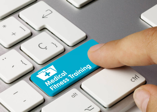 Medical Fitness Training Written on Blue Key of Metallic Keyboard. Finger pressing key. - Photo, Image