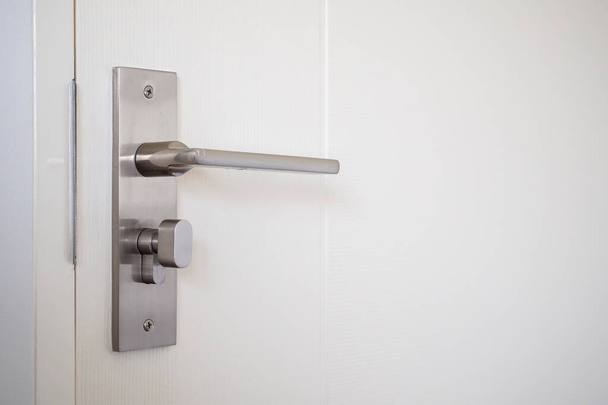 Modern door handle with on white door - Zdjęcie, obraz
