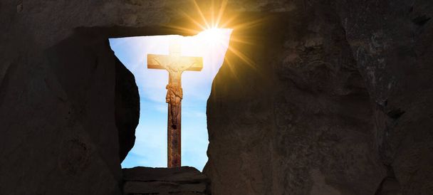 Pasen achtergrond banner panorama, religieus landschap -Kruisiging van Jezus Christus in Golgota / Golgotha jerusalem israel, leeg graf met uitzicht op gekruisigde Jezus aan het kruis, verlicht door de zon - Foto, afbeelding