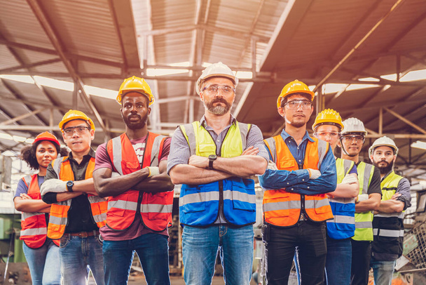 Group of Worker Engineer Teamwork people mix race in Heavy Industry standing confident.selective focus at center man - Photo, Image