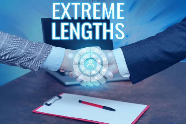 Text sign showing Extreme Lengths. Business overview Make a great or extreme effort to do something better Hands Shaking Signing Contract Unlocking New Futuristic Technologies. - Photo, Image