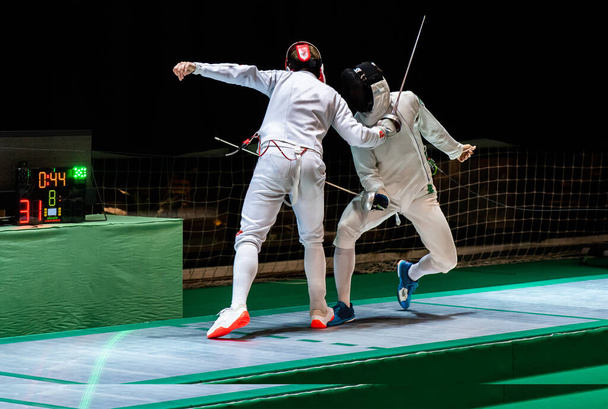 Fencer  with fencing sword. Fencers duel concept - Photo, Image