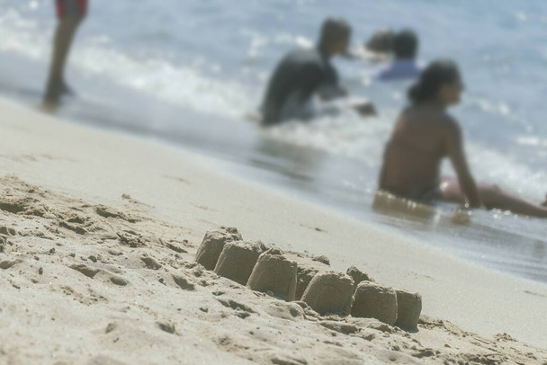 children playing with sand on the beach - Foto, Imagen