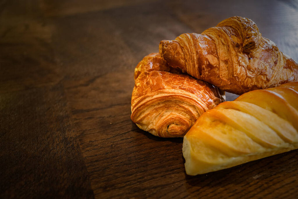 fresh homemade croissants on the wooden background - Фото, изображение