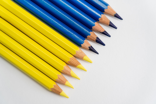 Top view of blue and yellow pencils on white background - Фото, зображення
