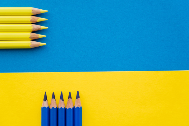 Top view of color pencils on ukrainian flag with copy space - Φωτογραφία, εικόνα
