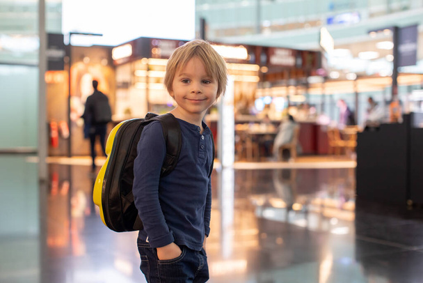 Cute  baby boy waiting boarding to flight in airport transit hall near departure gate. Active family lifestyle travel by air with child on vacation - Fotografie, Obrázek
