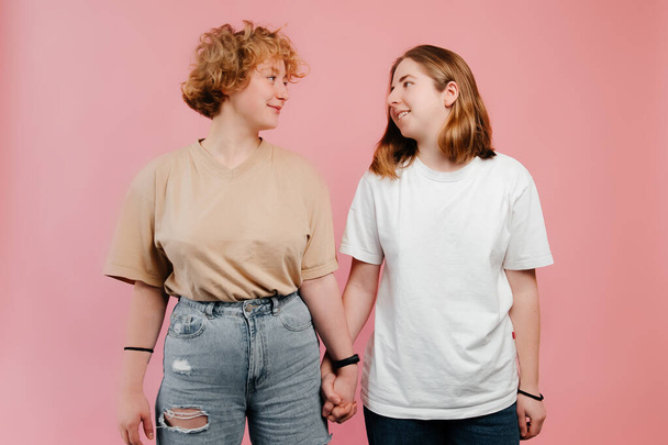 Portrait of young lesbian couple in casual clothes, ready to celebrate their feelings and St. Valentines Day - Fotoğraf, Görsel