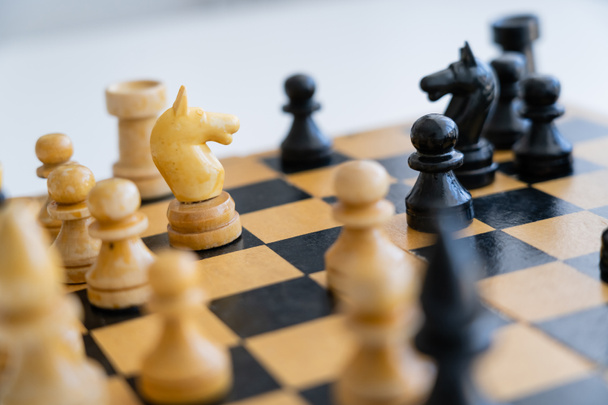 Wooden chess figures on chessboard on white background  - Foto, Imagem