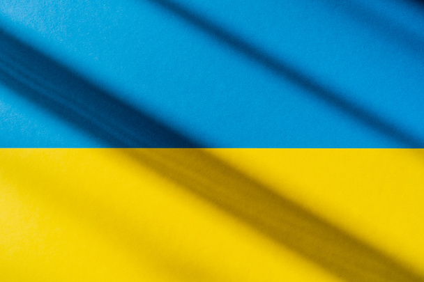 Top view of ukrainian flag with shadow  - Φωτογραφία, εικόνα