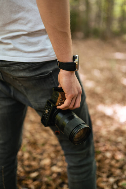 man with camera and a backpack on the background of the forest - Foto, immagini