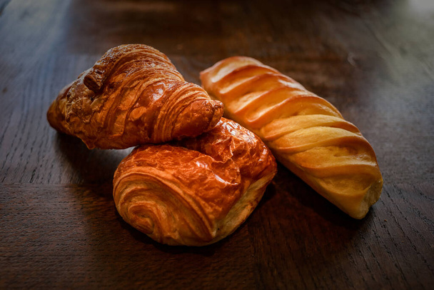 fresh homemade croissants on the wooden background - Photo, image