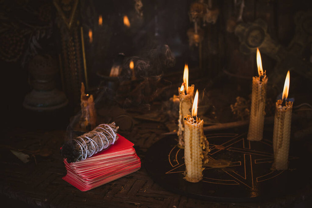 Candle burns on the altar, powerful magic among candles, pagan or wicca concept - Photo, Image
