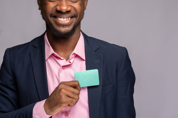 handsome african american man with paper bag on color background - Фото, зображення