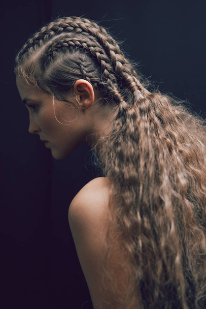 Beautiful portrait of a girl with an art hairstyle - Фото, зображення