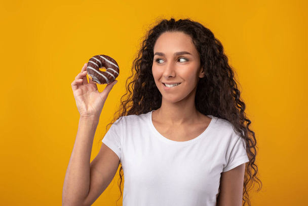 Funny Latin Lady Holding Doughnut Cake At Studio - Photo, Image