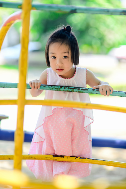 Asian little kid playing in the amusement park  - Фото, зображення