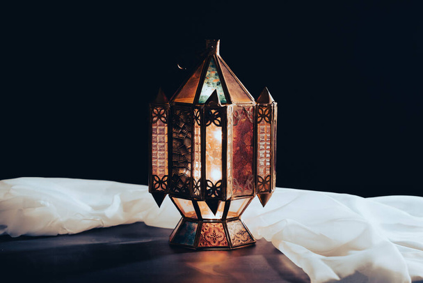 Ramadan Kareem background. Ornamental Arabic lantern glowing at night - Fotó, kép