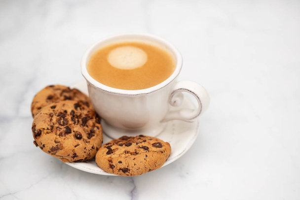 a cup of coffee with cookies chocolate drops on white - Photo, Image