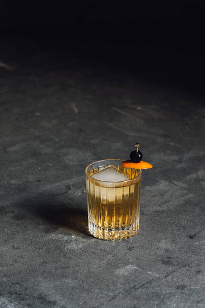 glass of whiskey with ice cubes on a dark background - Photo, Image